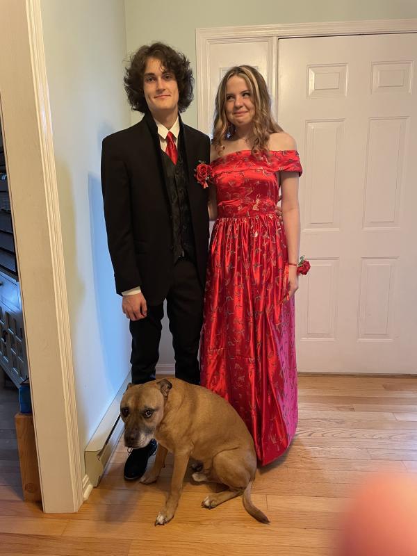 Junior Kayla Werner is all smiles in her off-the-shoulder butterfly brocade gown. She crafted a matching tie for date Xander George. Even pet Crash approved.